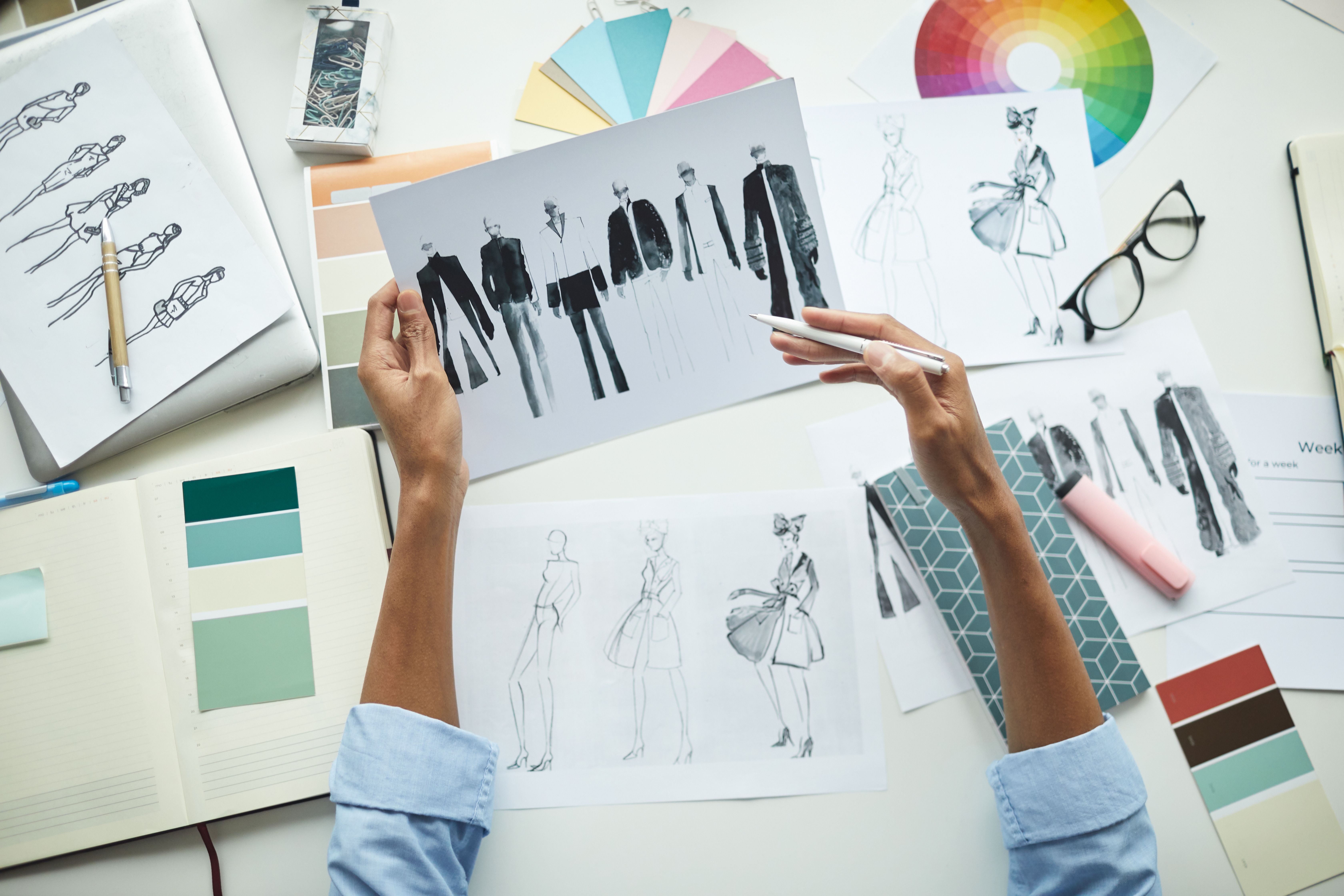 designer-examining-sketches-of-clothes-2022-02-02-03-56-42-utc.jpg